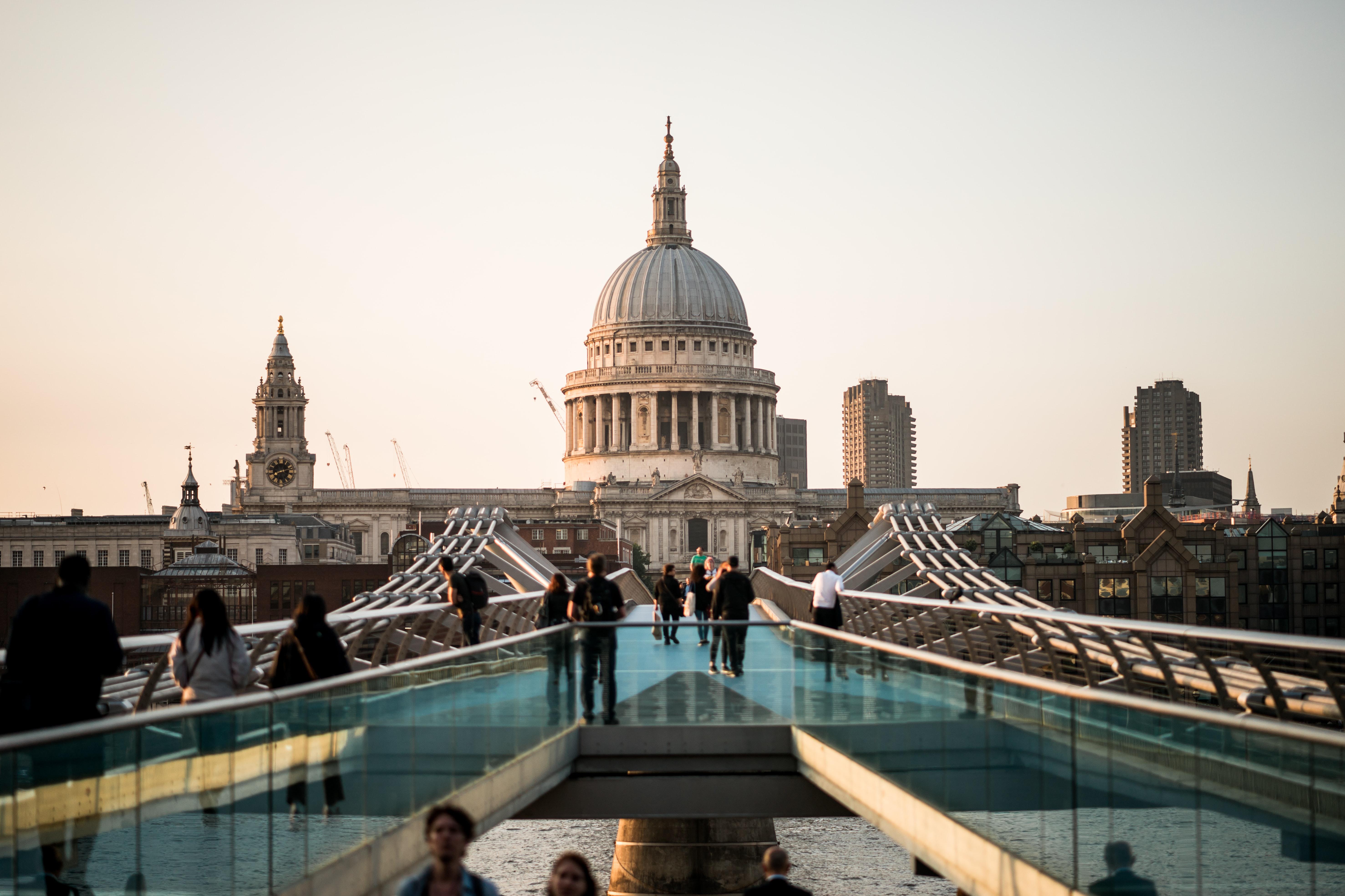 Millennium Bridge leading to St Paul’s Cathedral in London at sunset.