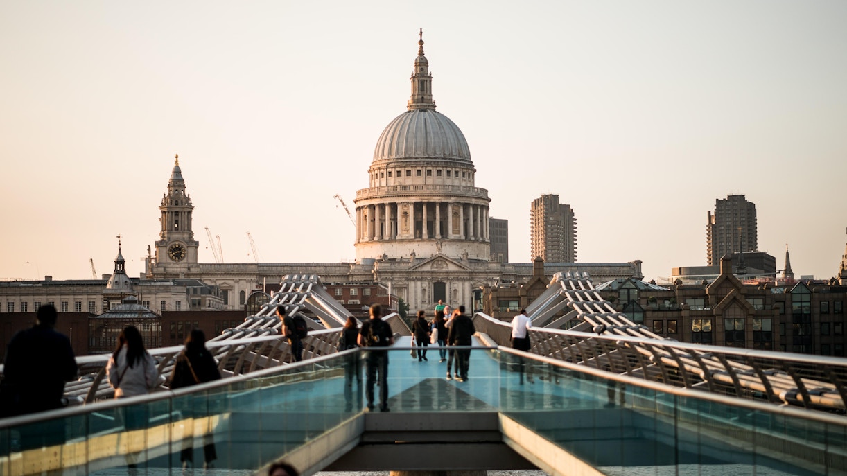 Millennium Bridge leading to St Paul’s Cathedral in London at sunset.
