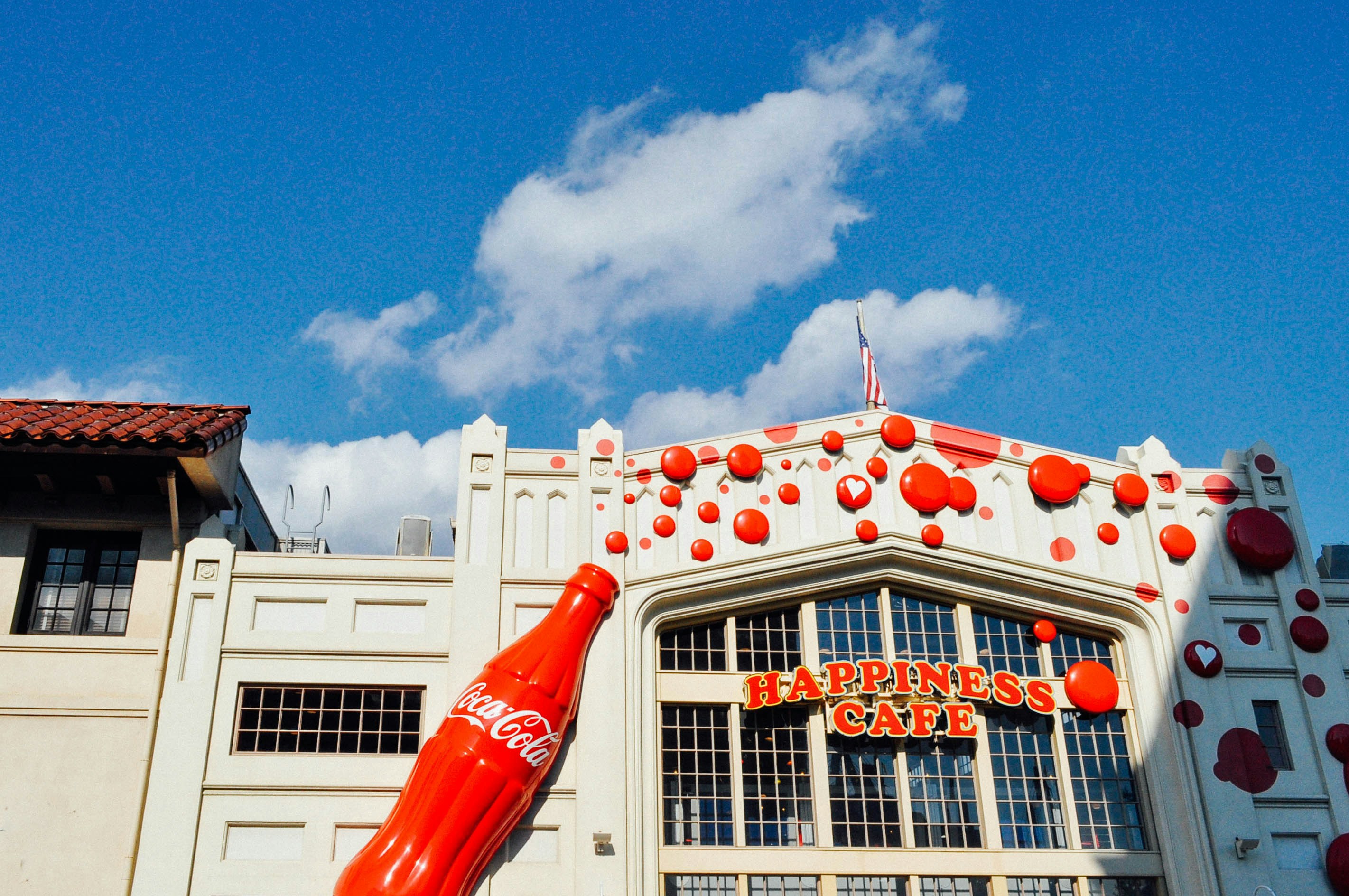 Happiness Cafe facade with Coca-Cola bottle at Universal Studios Japan, San Francisco area.