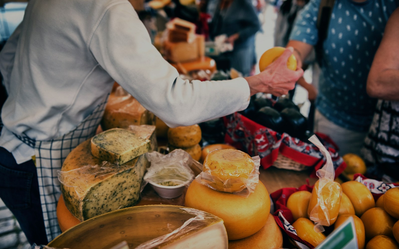 Cheese vendor at Amsterdam market during New Year festivities.