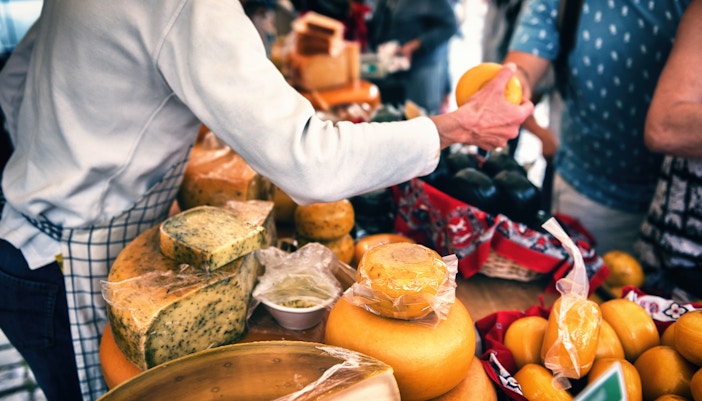Cheese vendor at Amsterdam market during New Year festivities.