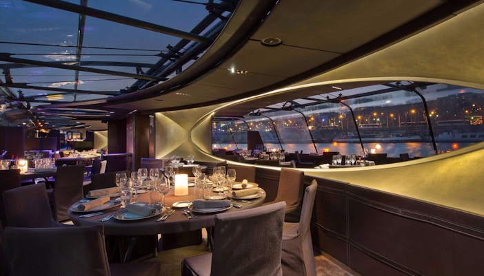 Seine River dinner cruise with Eiffel Tower view in Paris.