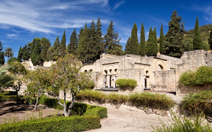 Medina Azahara ruins with cypress trees in High Garden, Cordoba.