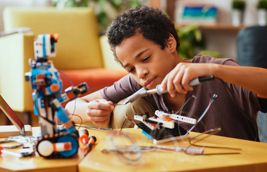 Child assembling a robot