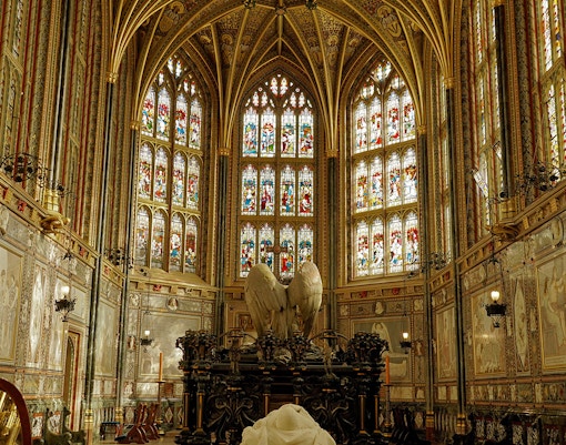 Stained glass windows and ornate Gothic interior of St George's Chapel, Windsor Castle, England.