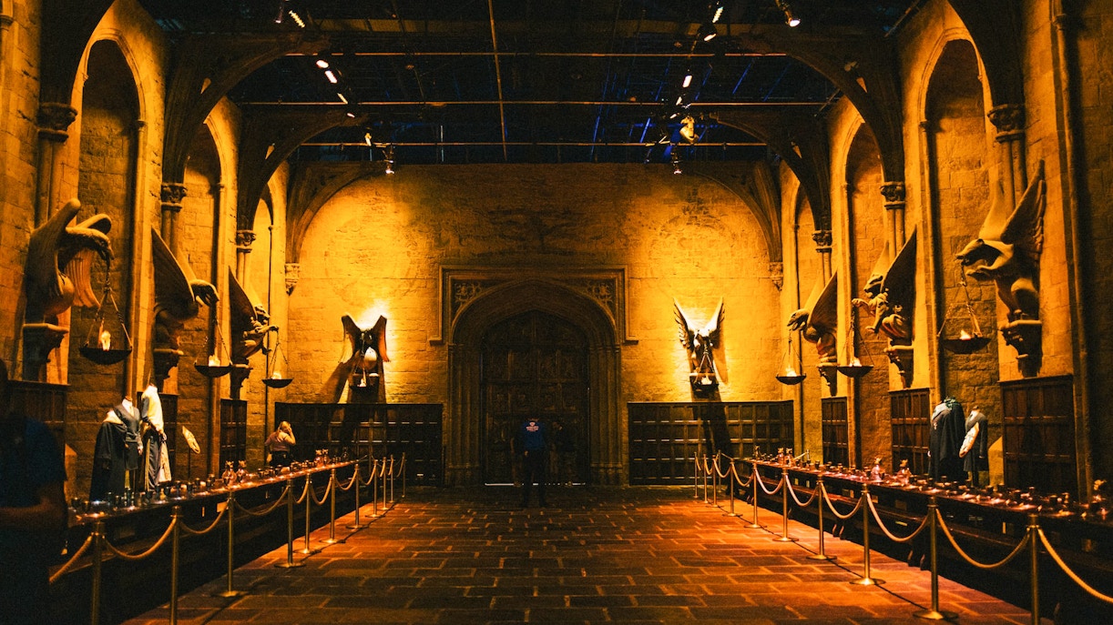 Great Hall set at Harry Potter Studio Tour, featuring long tables and stone arches.