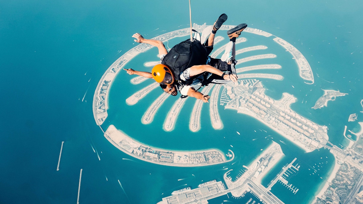 Skydiver over Palm Jumeirah, Dubai, experiencing a thrilling aerial view.