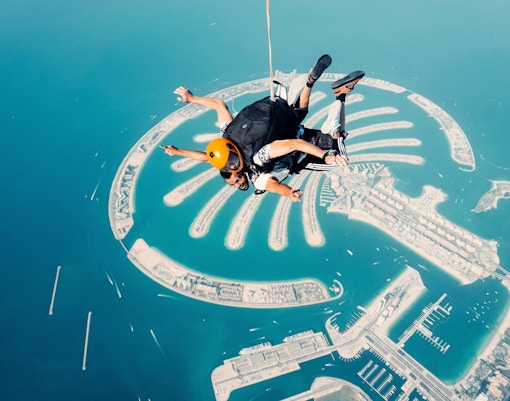Skydiver over Palm Jumeirah, Dubai, experiencing a thrilling aerial view.