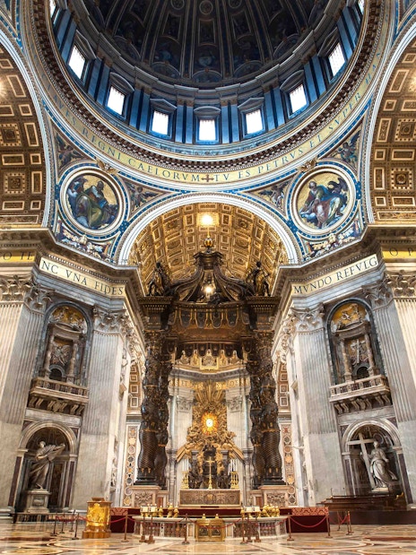 St. Peter's Basilica interior with ornate dome and altar in Vatican City.
