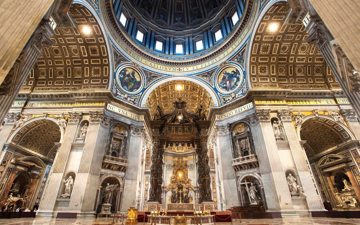 St. Peter's Basilica interior with ornate dome and altar in Vatican City.