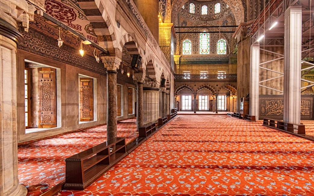 Royal Kiosk interior with ornate columns and stained glass in the Blue Mosque, Istanbul.