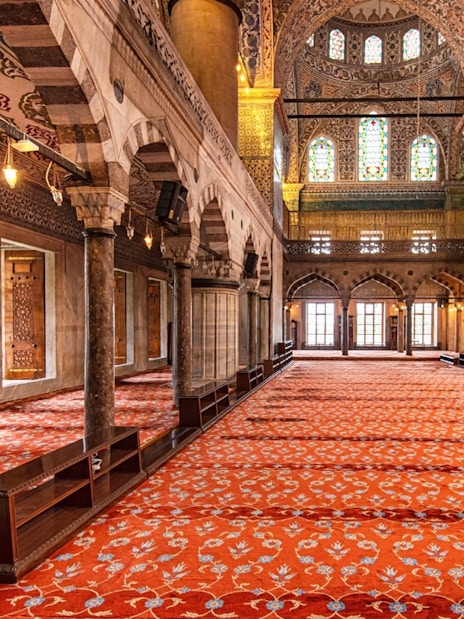 Royal Kiosk interior with ornate columns and stained glass in the Blue Mosque, Istanbul.
