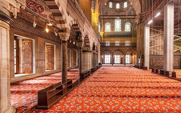 Royal Kiosk interior with ornate columns and stained glass in the Blue Mosque, Istanbul.