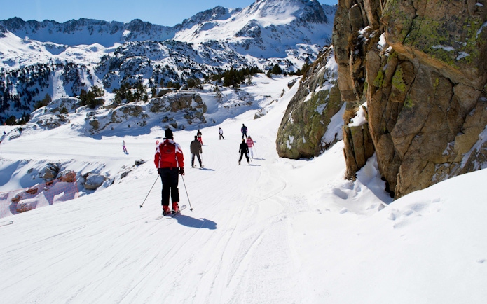 Skiers on a snowy slope in the Pyrenees, Andorra, near Barcelona.
