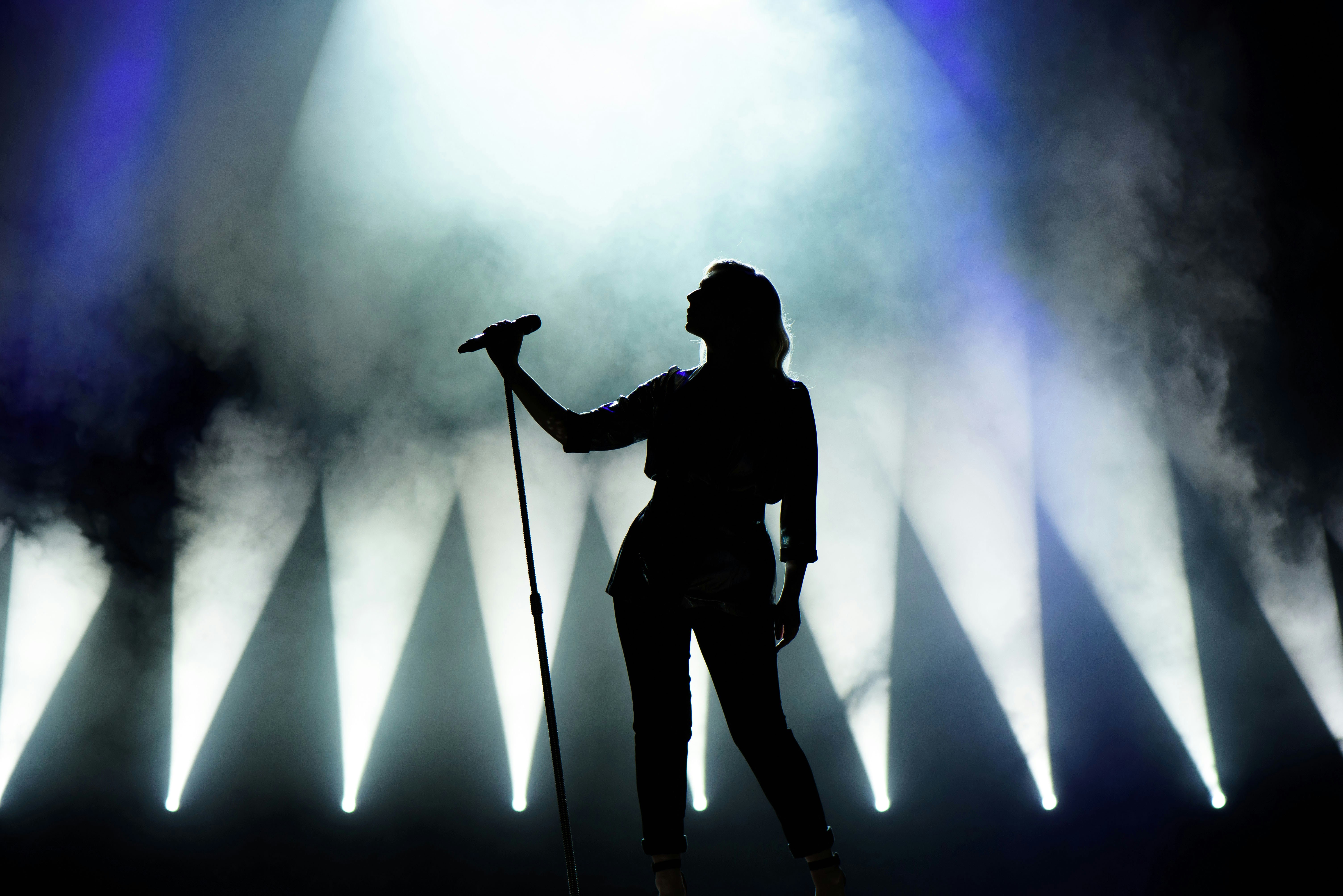 Performer on stage with spotlight 