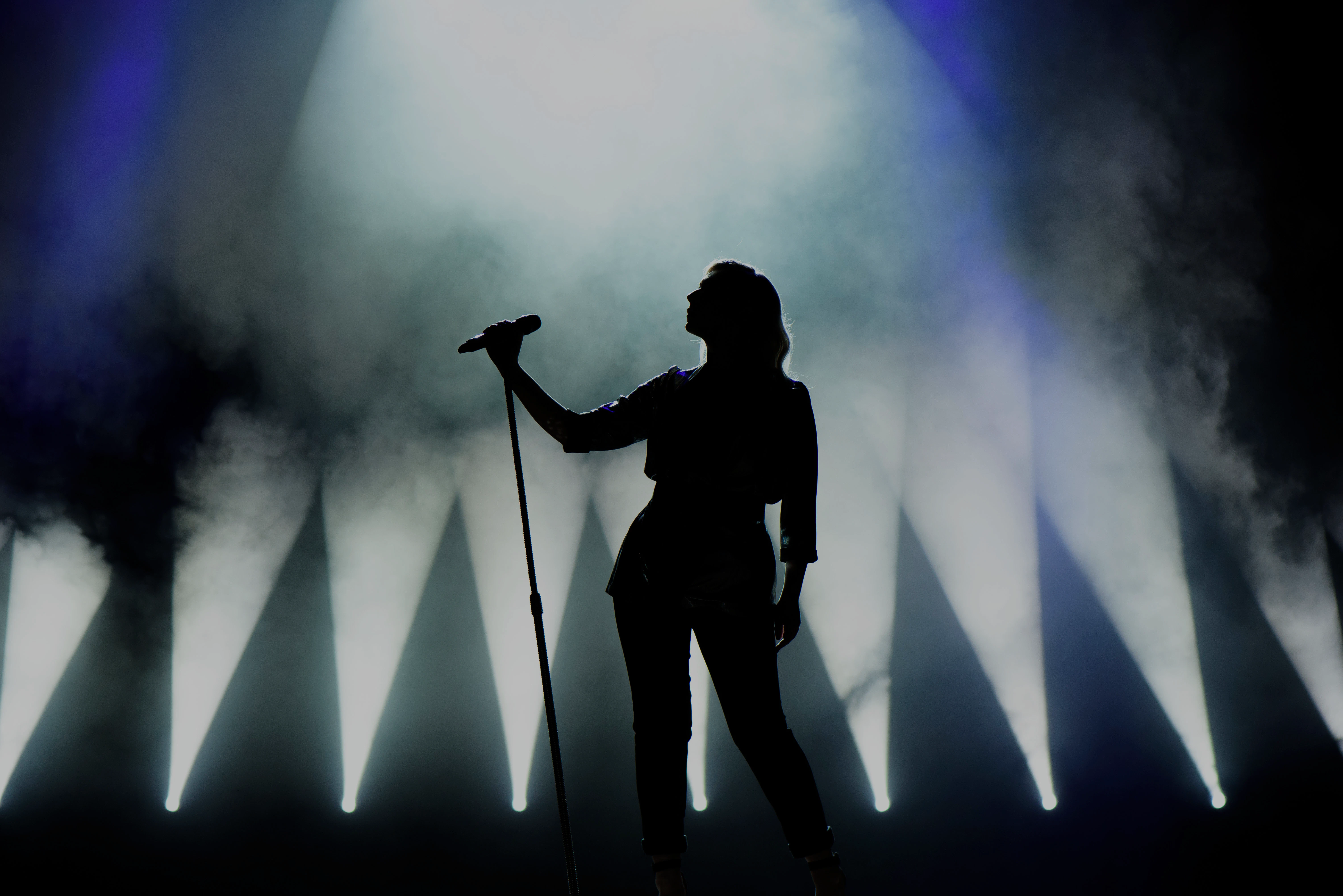 Performer on stage with spotlight during New Year live show in Berlin.