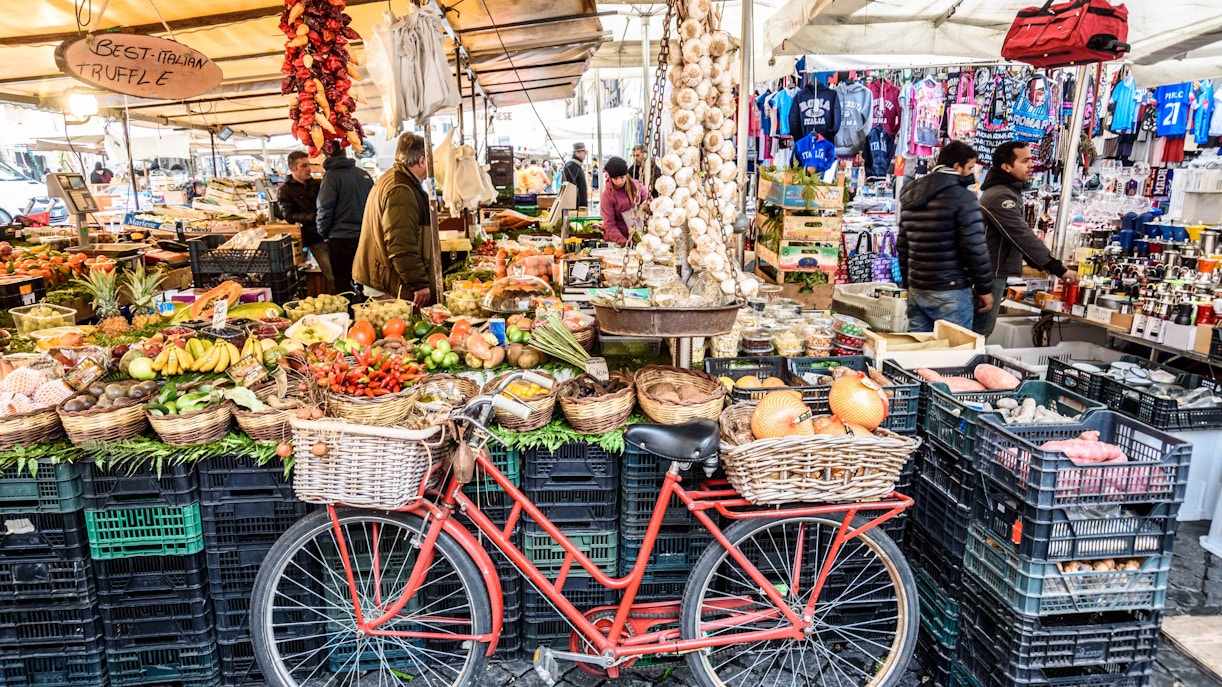 Campo de’ Fiori market stalls with fresh produce in Rome, ideal for family exploration.
