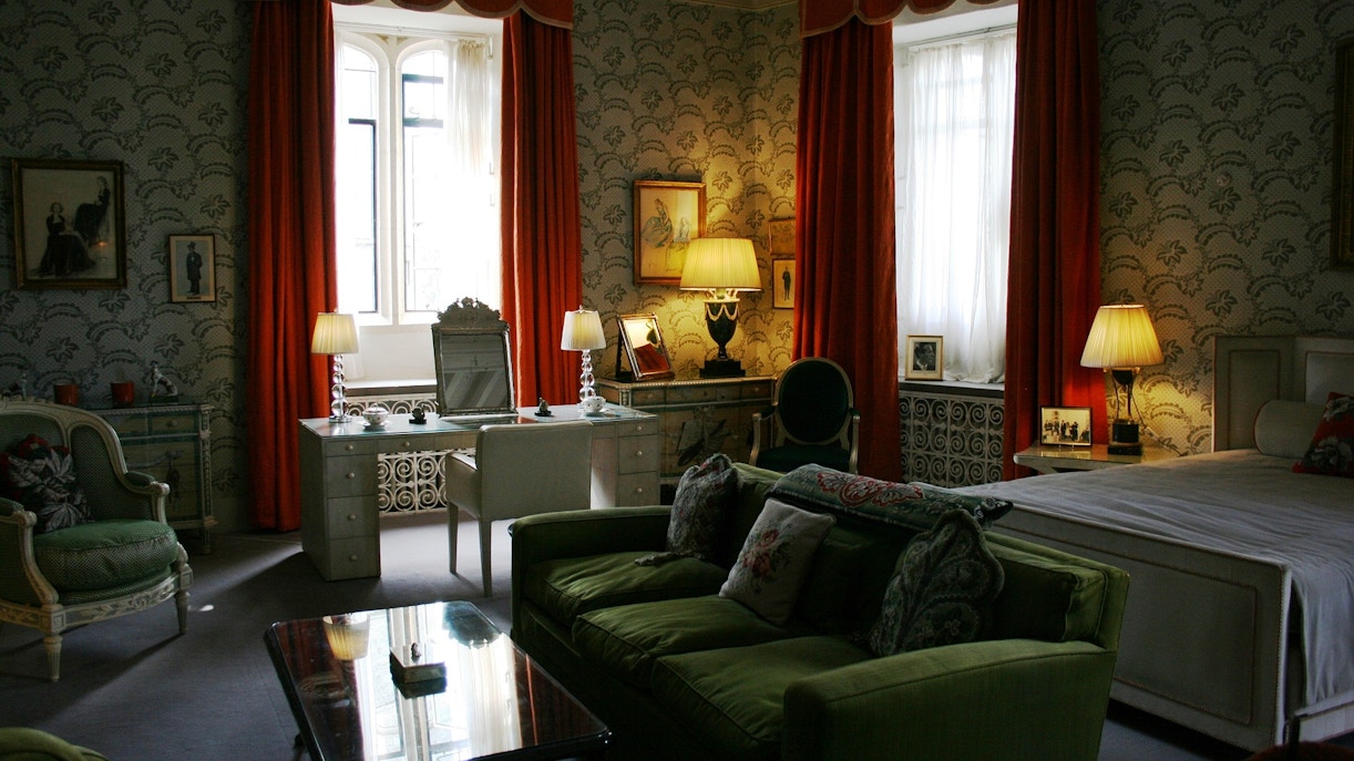 Leeds Castle accommodation interior with vintage decor and green furnishings.