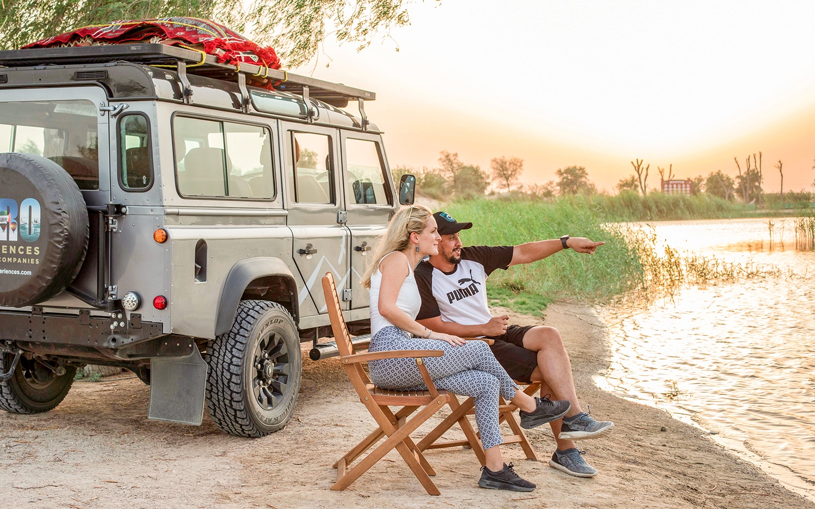 Camel ride through Dubai Desert Conservation Reserve with sand dunes in the background.