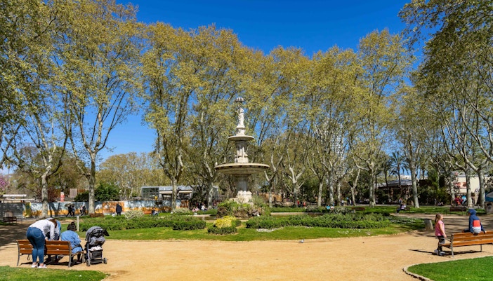 Barcelona Zoo entrance with a Barcelona Hop-on Hop-off bus in the foreground.