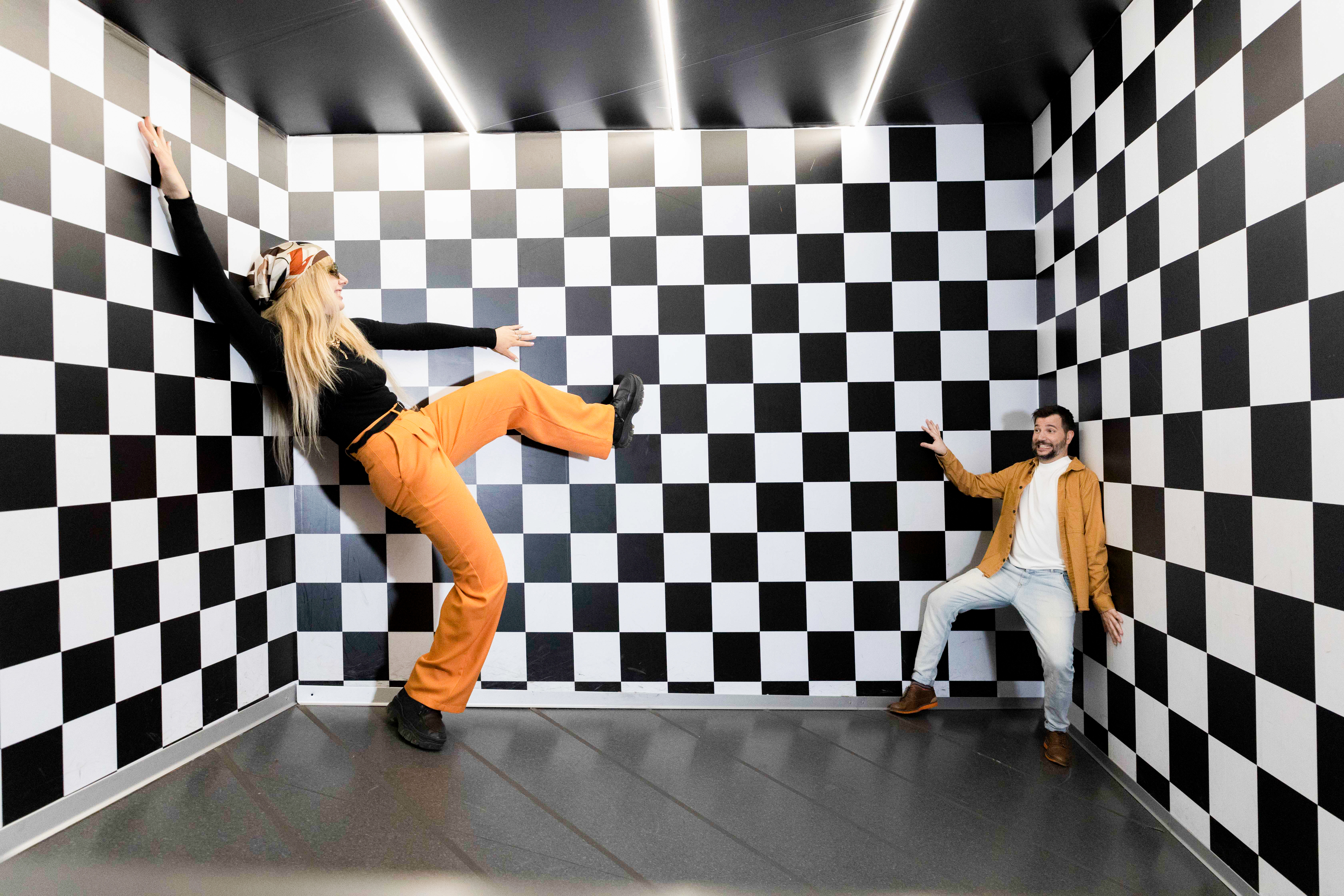 Ein Mann, der größer erscheint und ein Mann, der kleiner erscheint im Ames Raum in Berlin