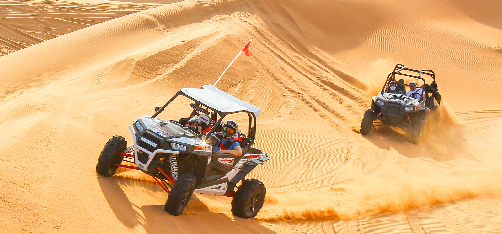 Dune buggy driving through Dubai desert during safari adventure.