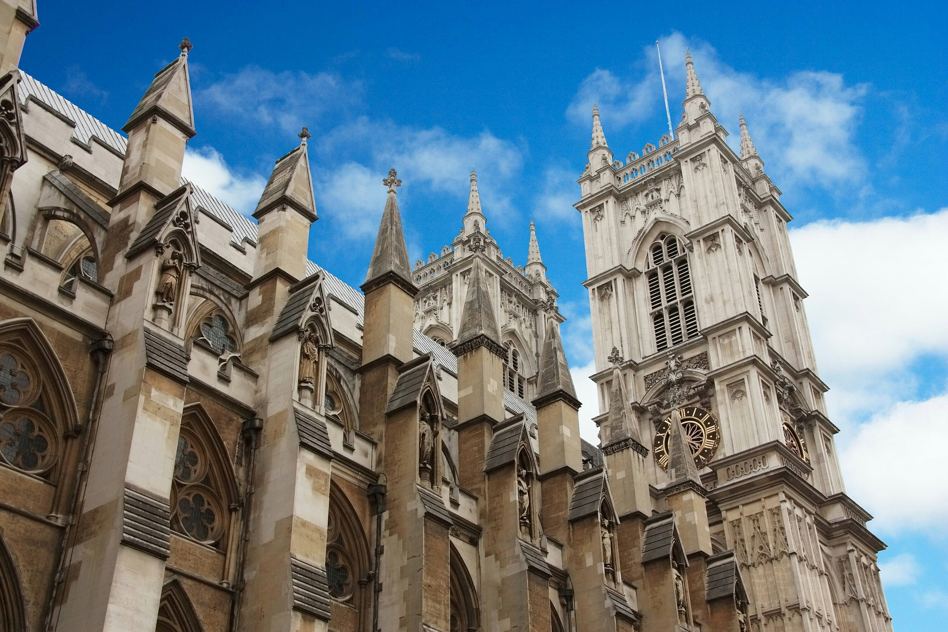 Westminster Abbey exterior with tourists in London, England.