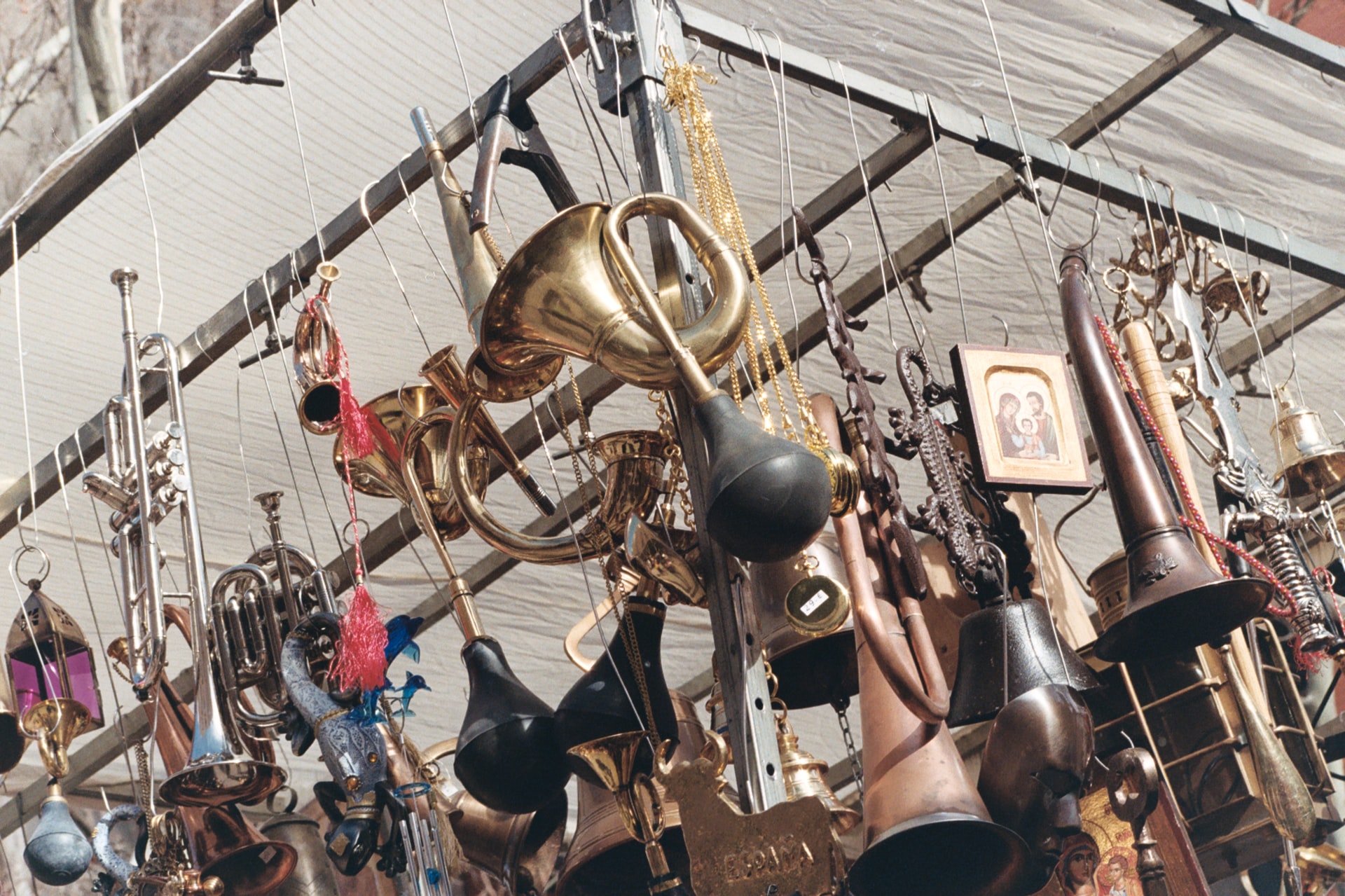 Vintage brass instruments and trinkets at El Rastro market, Madrid.
