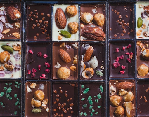 Artisanal chocolate display in a Rome shop with various handcrafted chocolates.