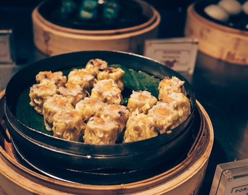 vendor serving dim sum to tourists.