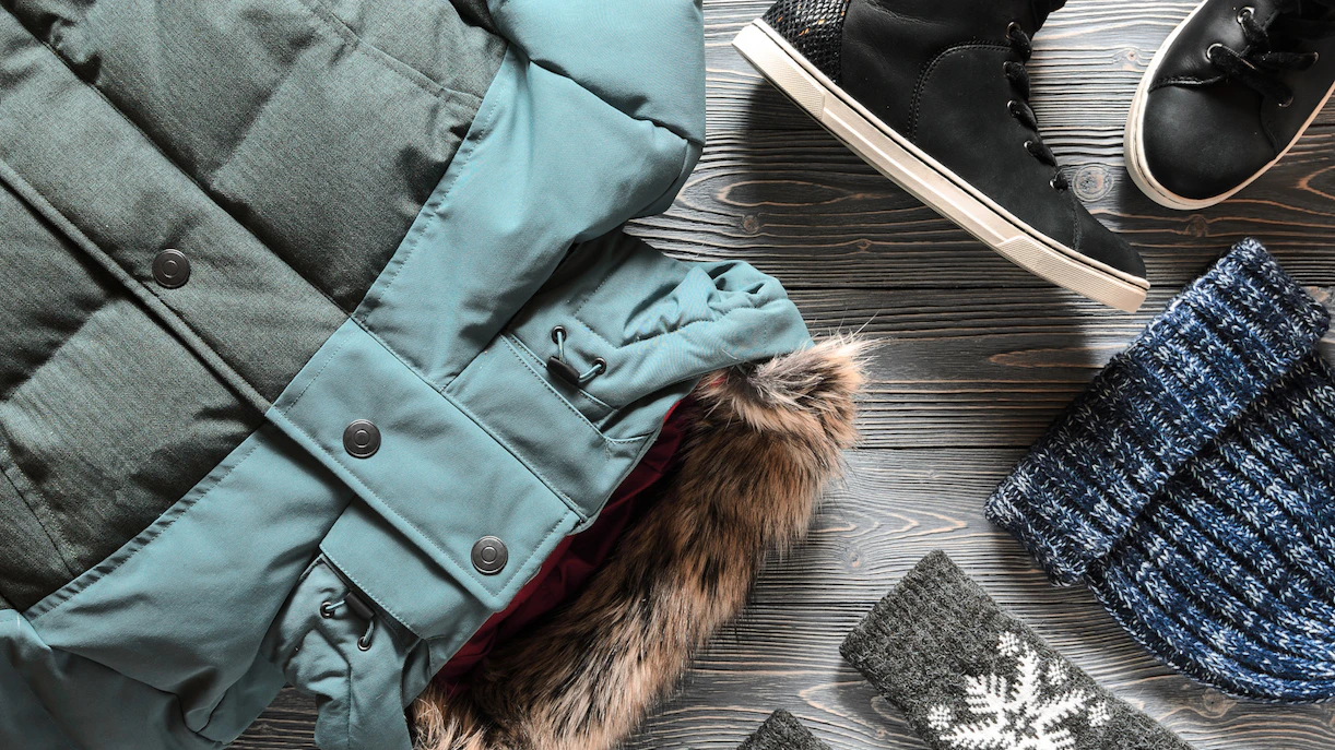 Winter clothing essentials for Rome, including a coat, boots, hat, and gloves.