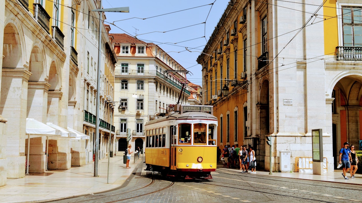 Lisbon Tram 28 navigating through historic city streets.