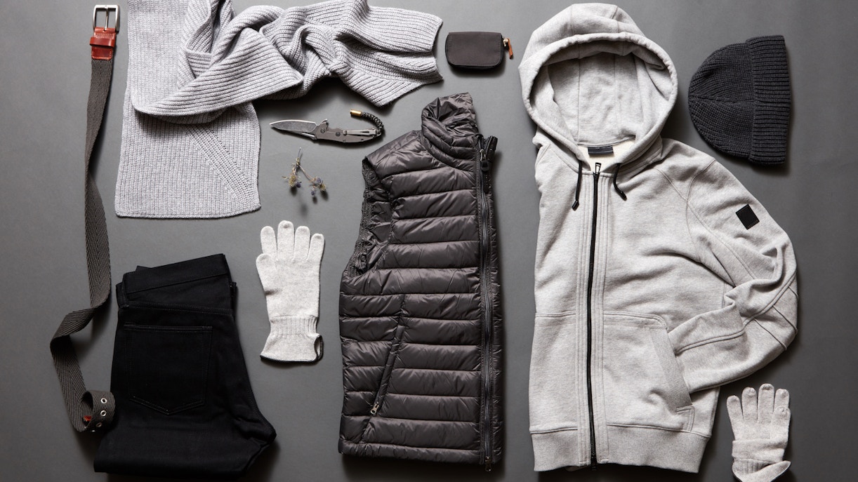 Winter clothing essentials for Rome, including a hoodie, scarf, gloves, and puffer vest.