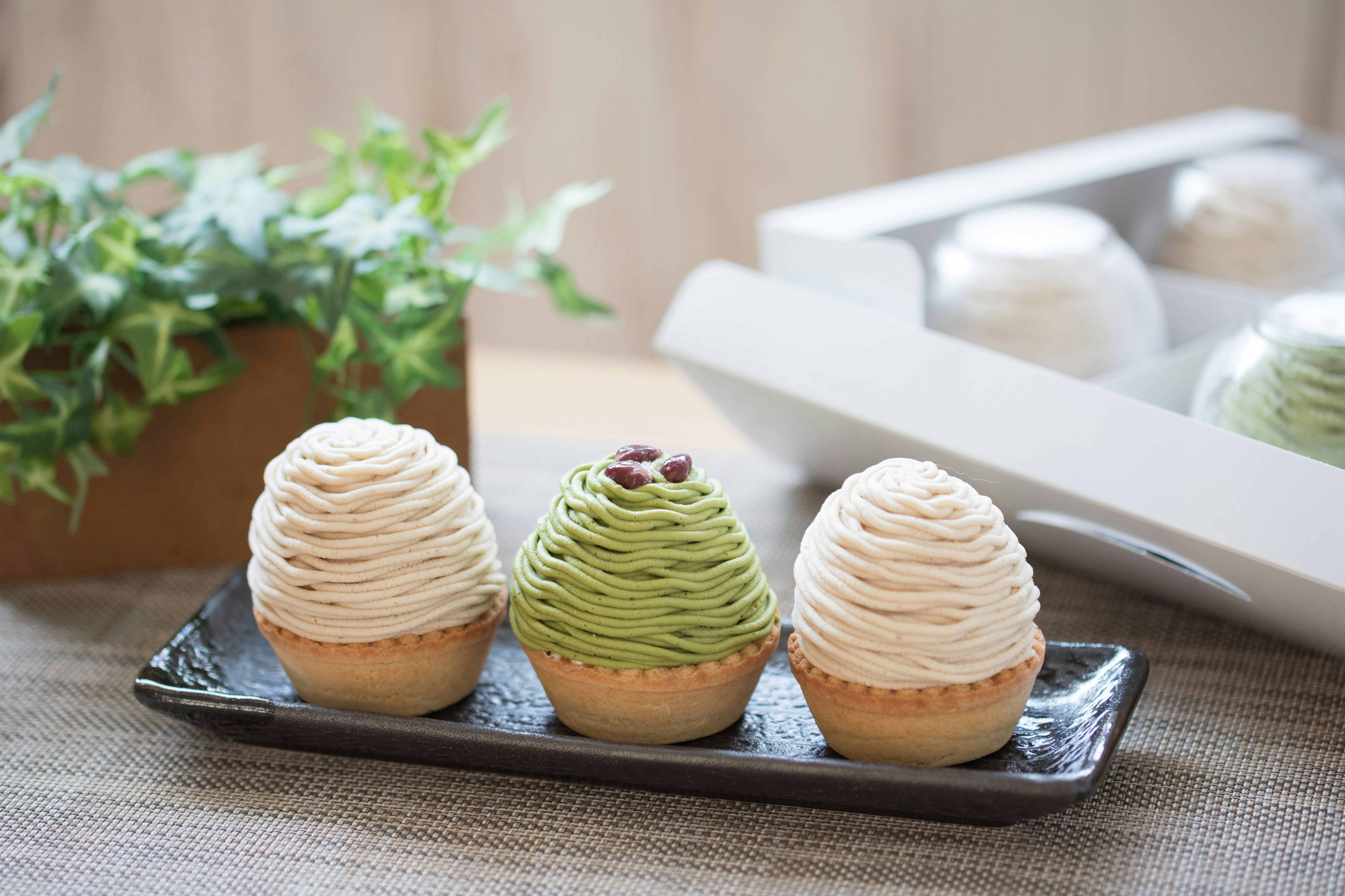 Mont Blanc pastries with chestnut and matcha cream on a tray.