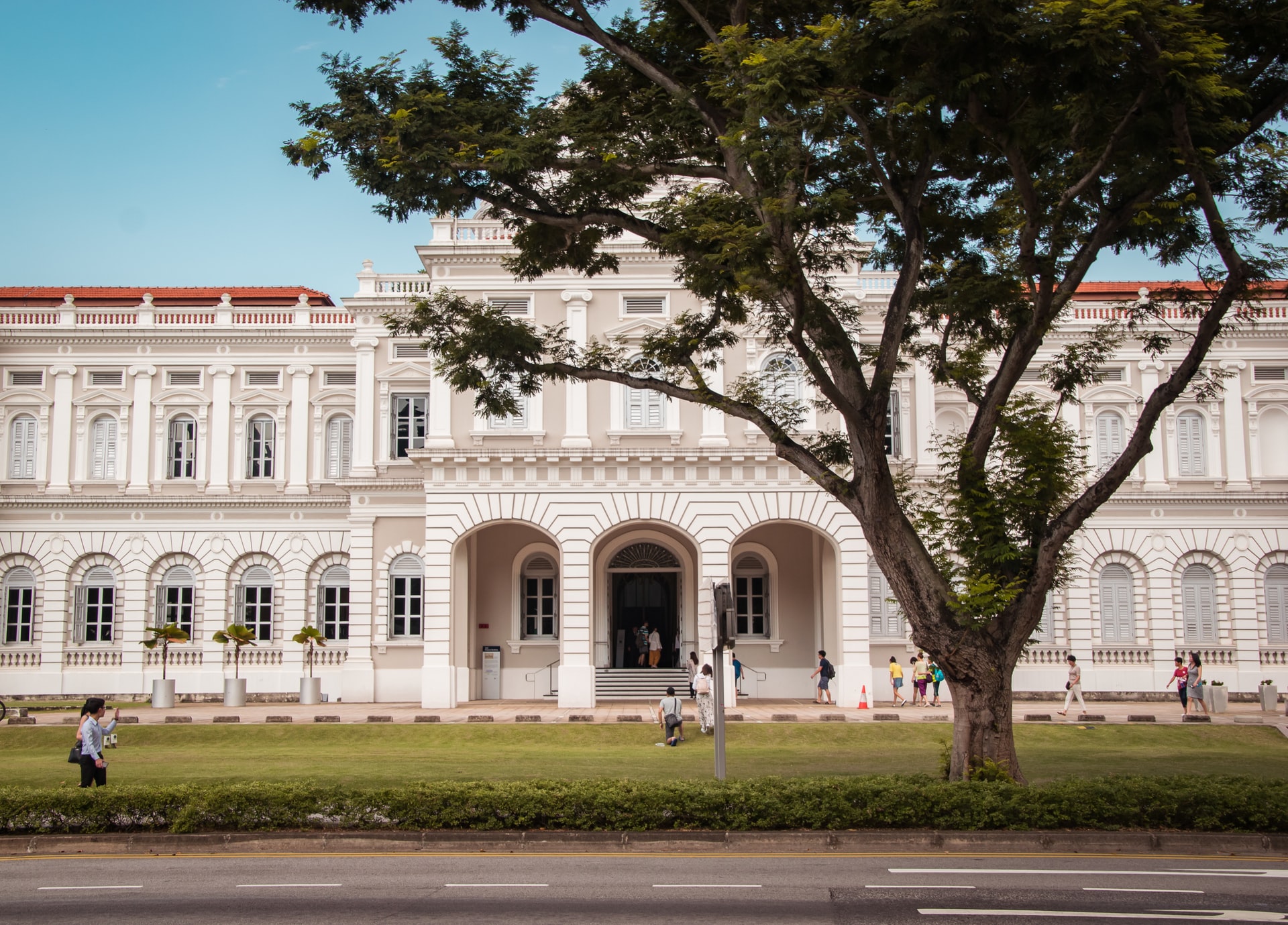 National Museum Singapore facade with visitors walking nearby.