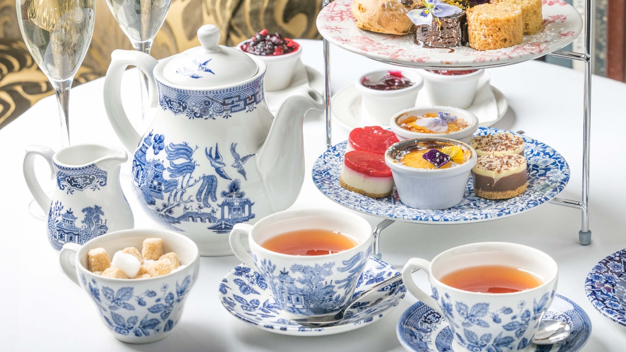 Afternoon tea set with pastries and tea at Kensington Palace exhibition.