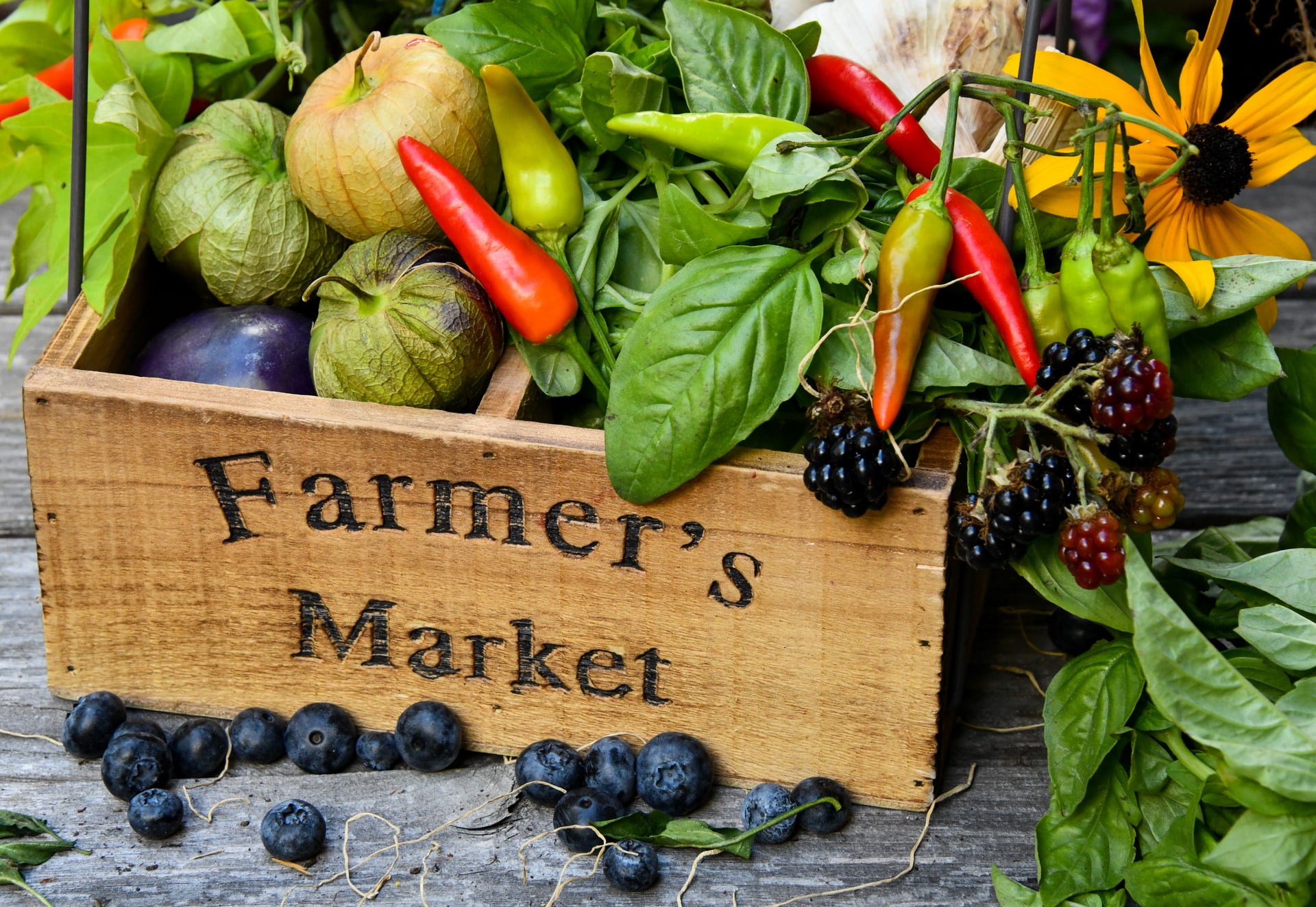 Fresh produce in a wooden crate at Paris street farmers market.