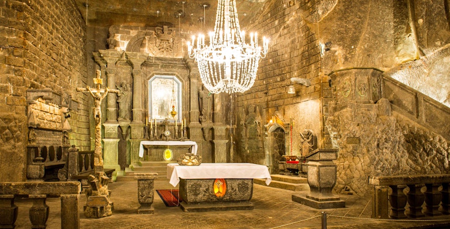 Wieliczka Salt Mine chapel with ornate salt carvings and chandelier.