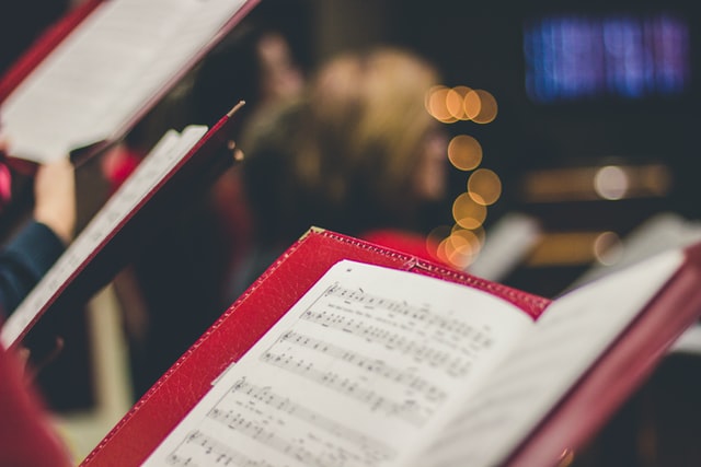 Choir singing from sheet music at Westminster Abbey.