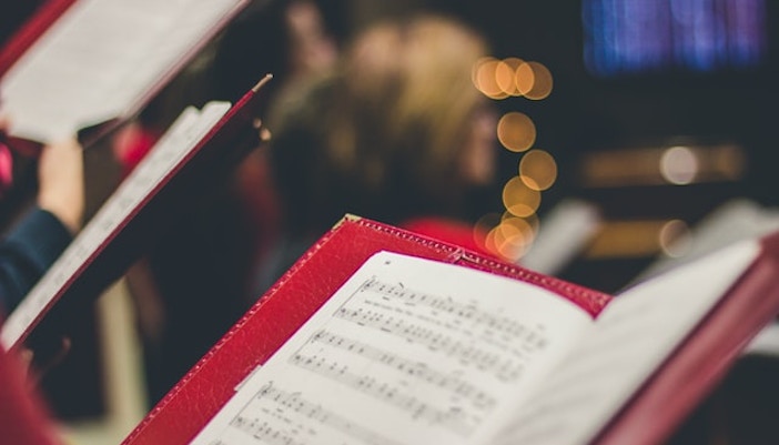 Choir singing from sheet music at Westminster Abbey.
