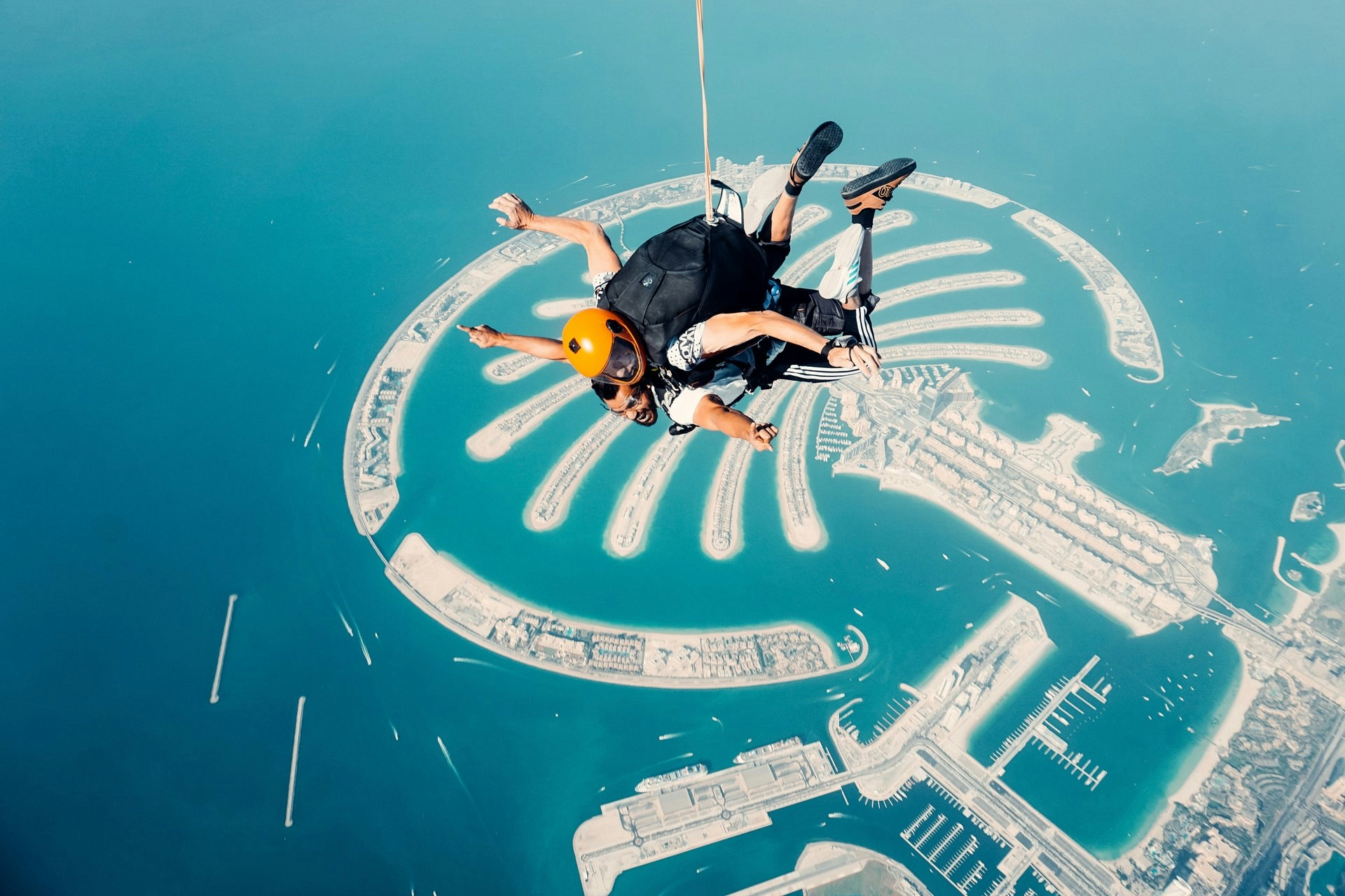 Skydiver over Palm Jumeirah, Dubai, with clear view of the island's fronds.