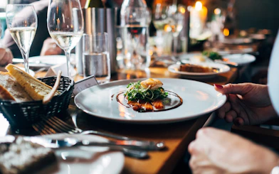 Dinner served on a Seine River cruise in Paris with wine and bread.