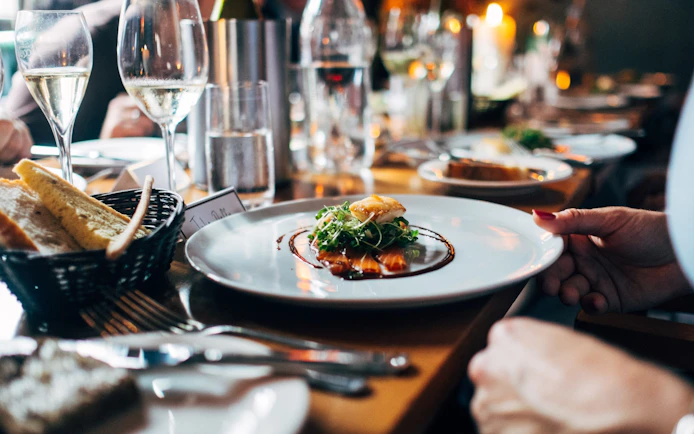 Dinner served on a Seine River cruise in Paris with wine and bread.