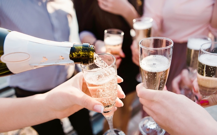 Pouring champagne into glasses during Blue Cave & Our Lady of The Rock boat tour.