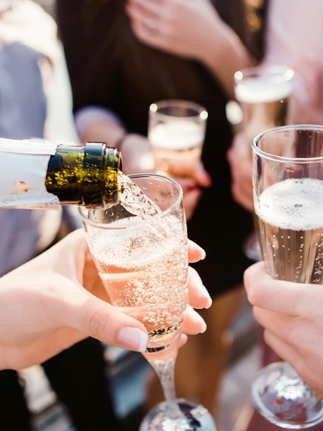 Pouring champagne into glasses during Blue Cave & Our Lady of The Rock boat tour.