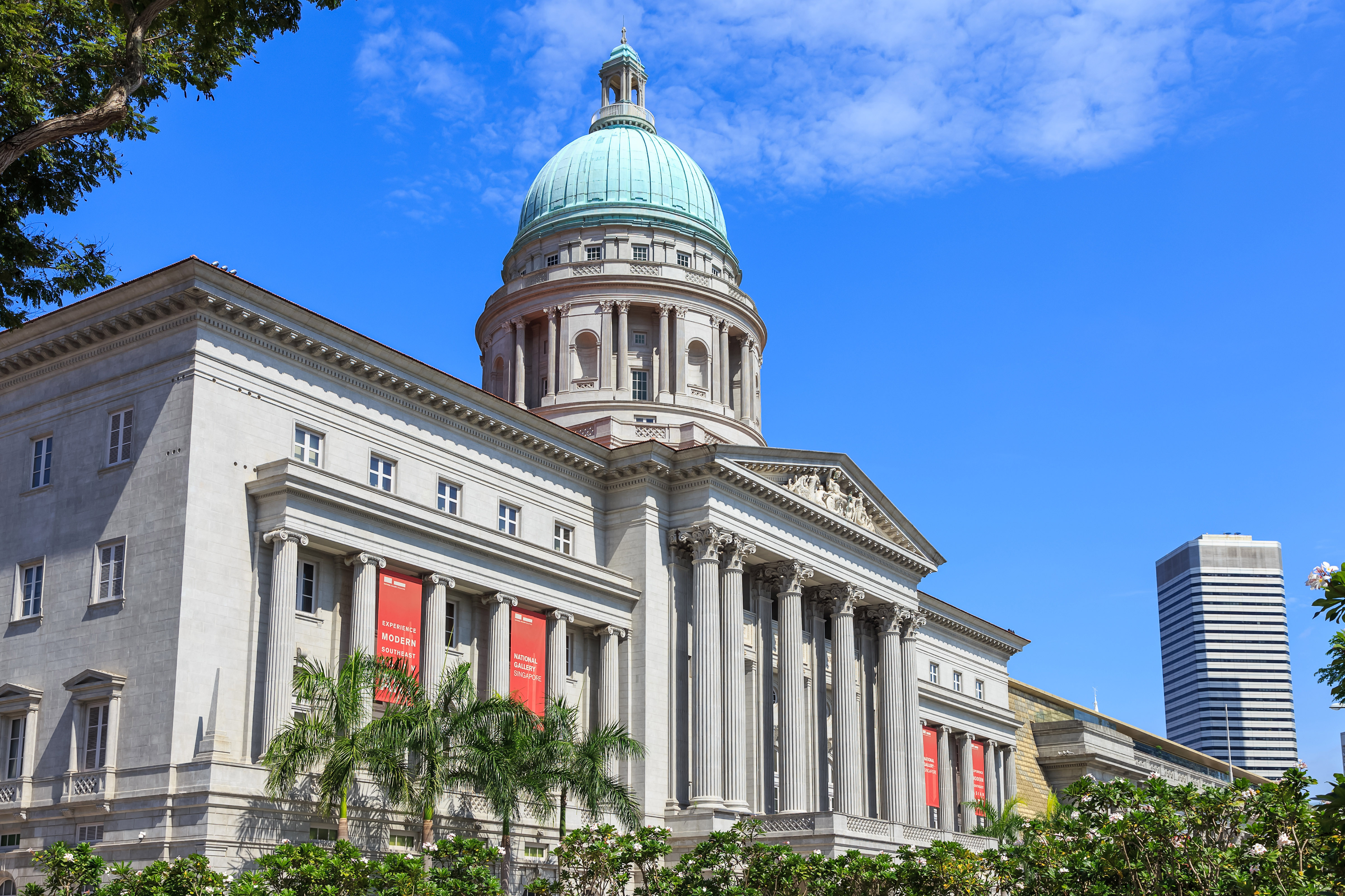 Visitors exploring the National Gallery of Singapore, showcasing a vast collection of modern art in a historic setting