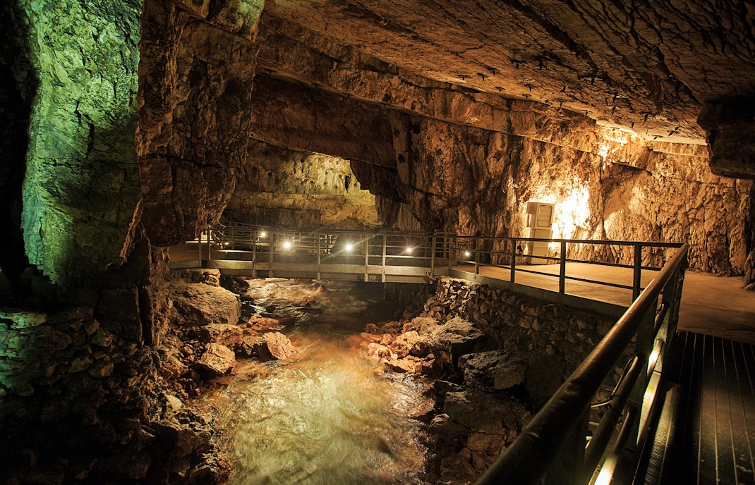 Naples Underground Roman waterways with ancient stone arches and dimly lit passageways.