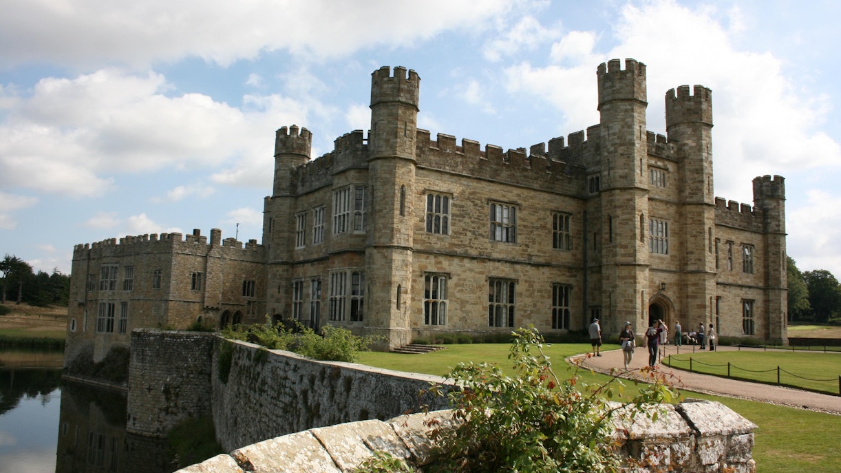 Leeds Castle in Kent with visitors walking along the path.