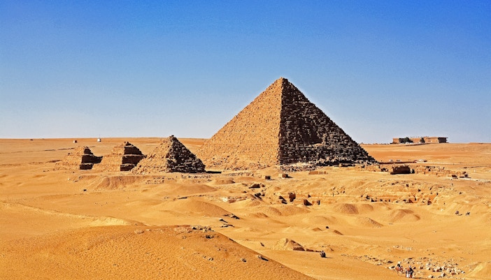 Pyramids of Giza with Menkaure Pyramid in the foreground, Egypt desert landscape.
