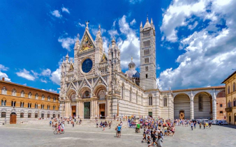 Tourists exploring the exterior of Florence Duomo on a guided tour.